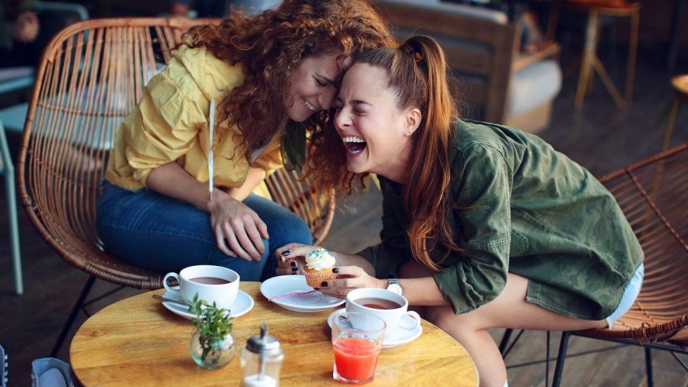 Two-women-laughing-at-coffee-shop-1500x825