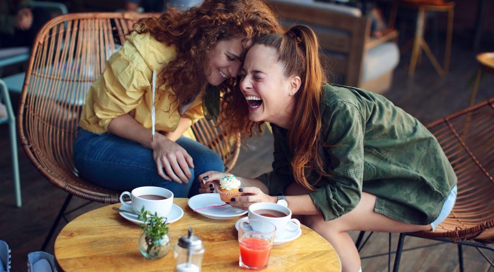 Two-women-laughing-at-coffee-shop