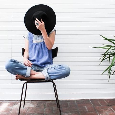 woman sitting on chair with legs crossed