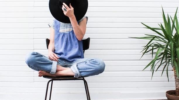 woman sitting on chair with legs crossed