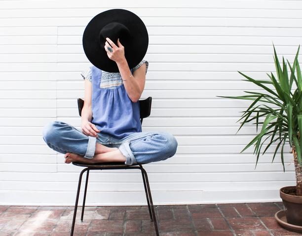 woman sitting on chair with legs crossed