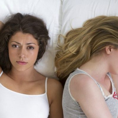 2 women lying in bed