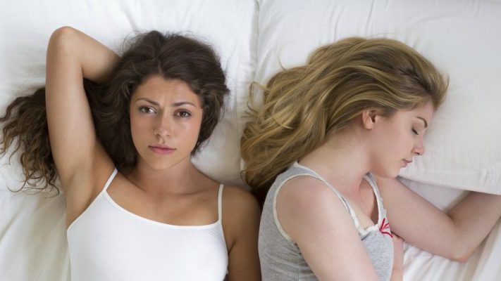 2 women lying in bed