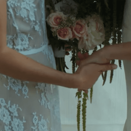 2 brides holding hands