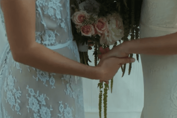 2 brides holding hands