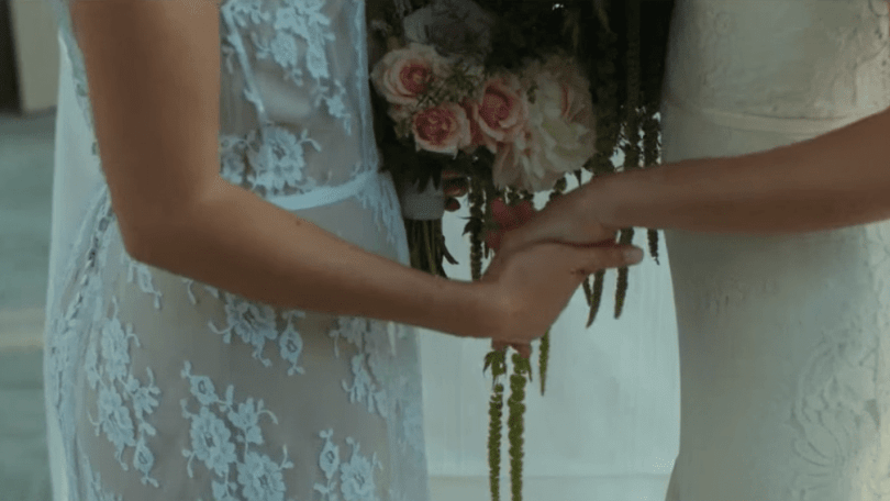 2 brides holding hands