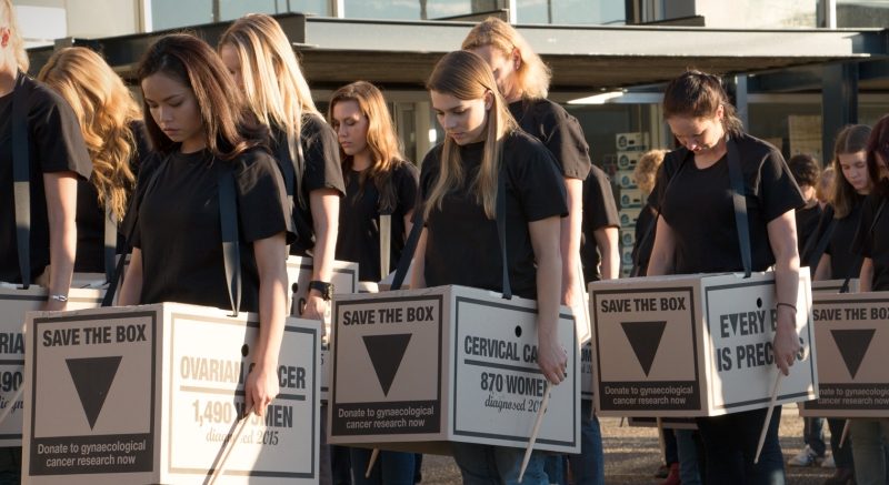 Woman posing with Save the box campaign