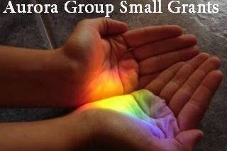 2 hands holding rainbow lights