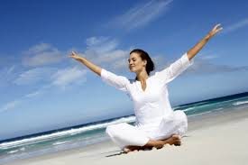 woman in white sitting on beach