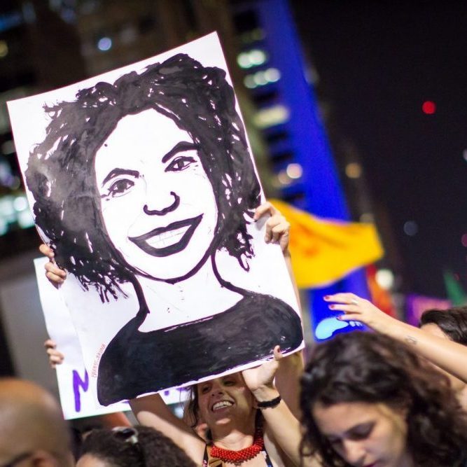 Demonstrator hold drawing of Marielle Franco Face