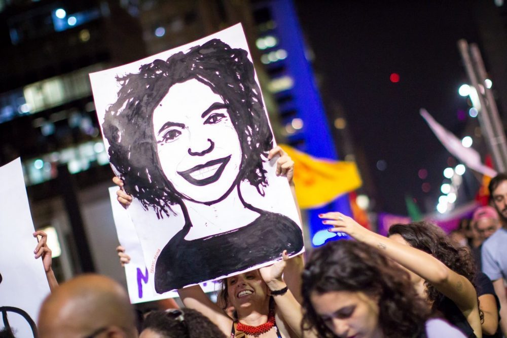 Demonstrator hold drawing of Marielle Franco Face