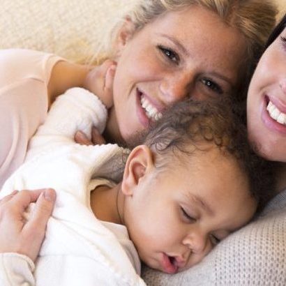 lesbian parents on lounge with baby