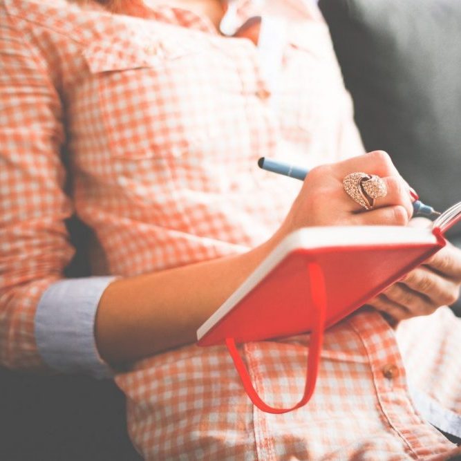 woman writing in a diary