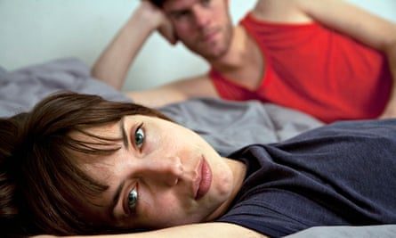 Unhappy couple lying in bed