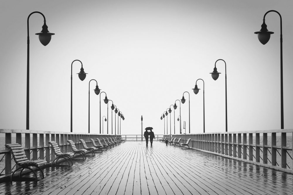 2 people walking under an umrella on a rainy day 