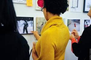 woman in yellow top looking at wall art