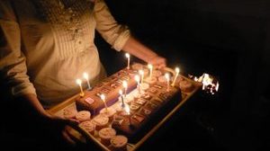 Woman holding tray with Birthday cupcakes