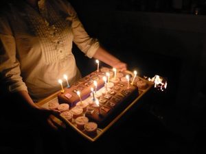 Woman holding tray with Birthday cupcakes