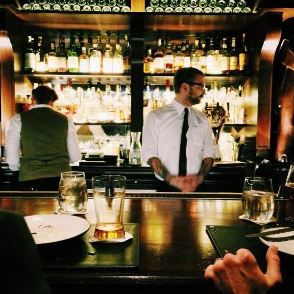 Male bartender behind a bar