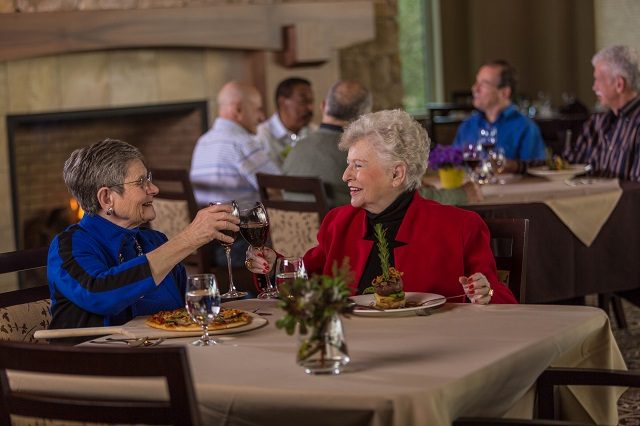 2 older women enjoying dinner