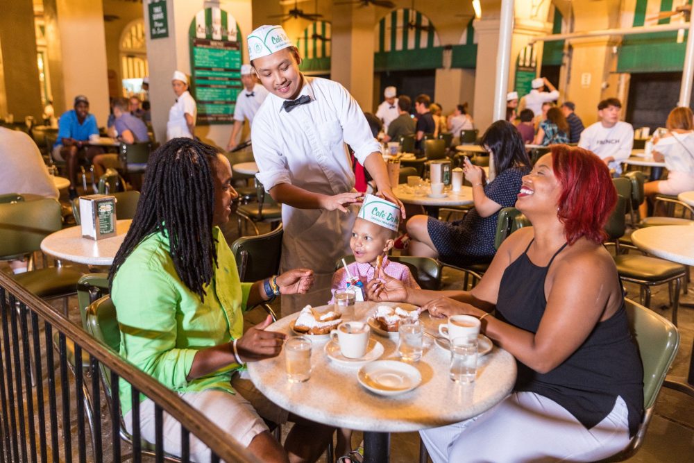 lesbians of color and son sitting in restaurant 