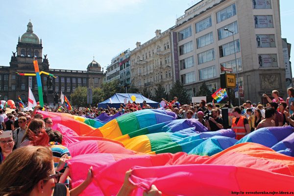 People in Prague holding Rainbow flag during Pride