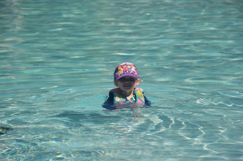 child swimming in pool 