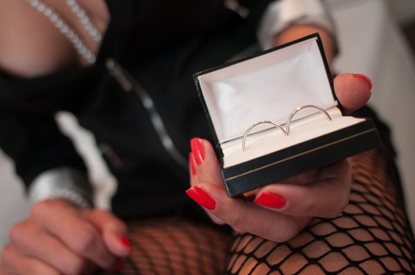 woman's hand showing off 2 wedding rings 