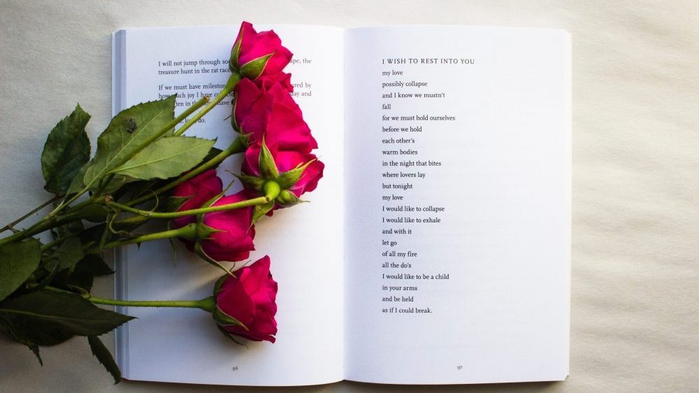 roses lying on poetry book