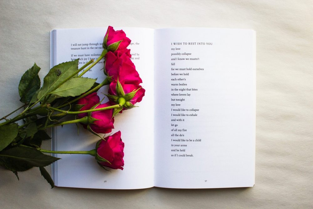 roses lying on poetry book