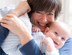 mother smiling holding baby