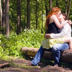 2 women kissing in forest