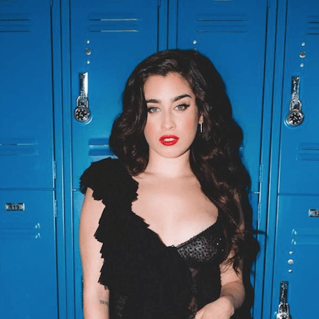 Lauren Jauregui in front of blue lockers