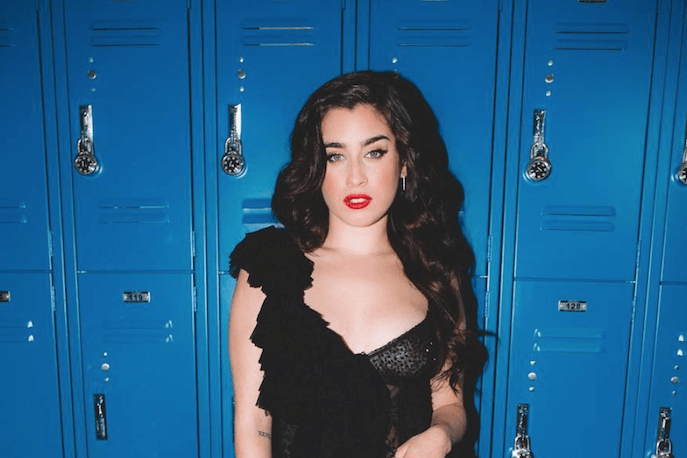 Lauren Jauregui in front of blue lockers