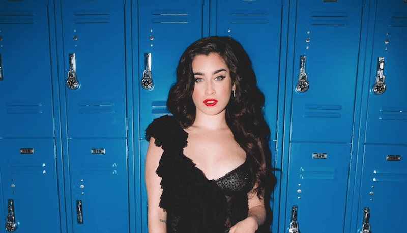 Lauren Jauregui in front of blue lockers