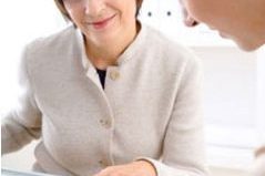 2 business women looking at paperwork