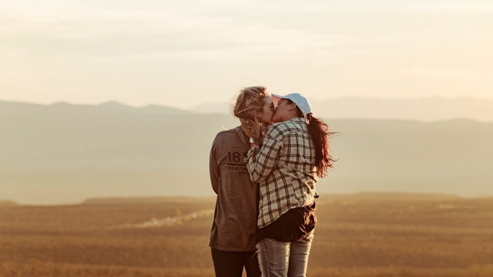 2 girls kissing in country side