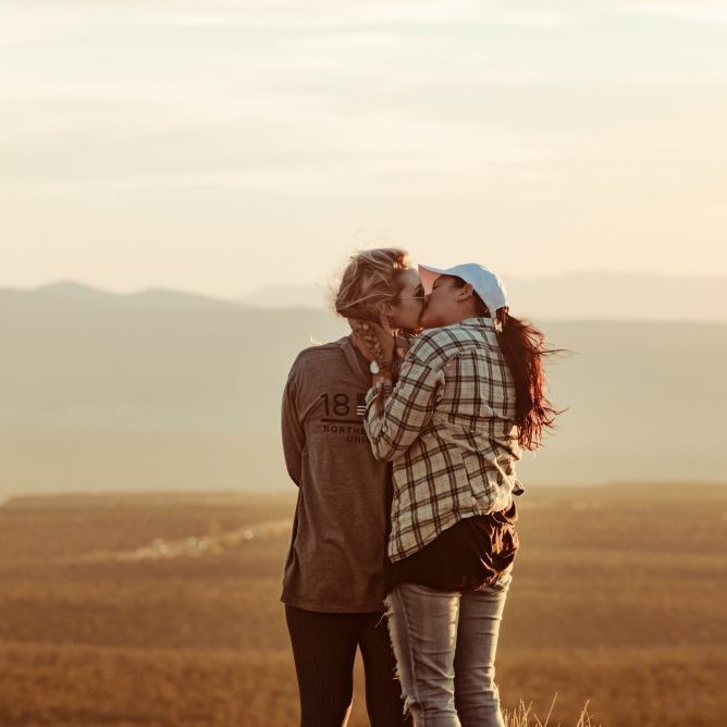 2 girls kissing in country side