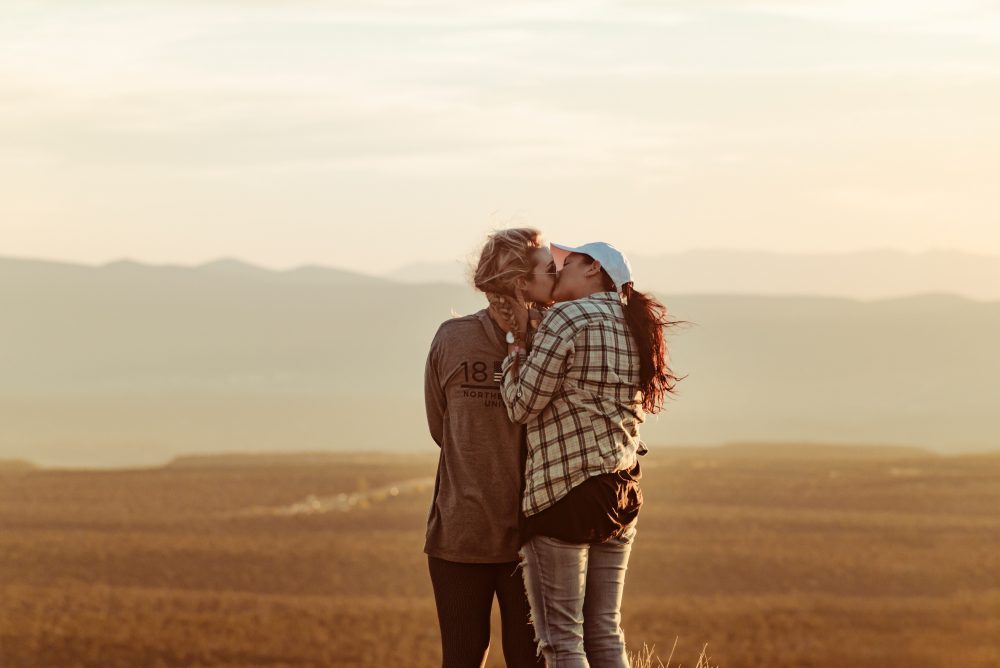 2 girls kissing in country side