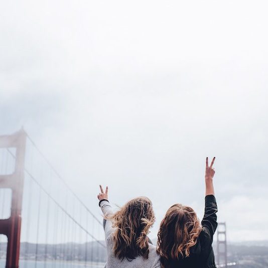 2 women in front of golden gate bridge