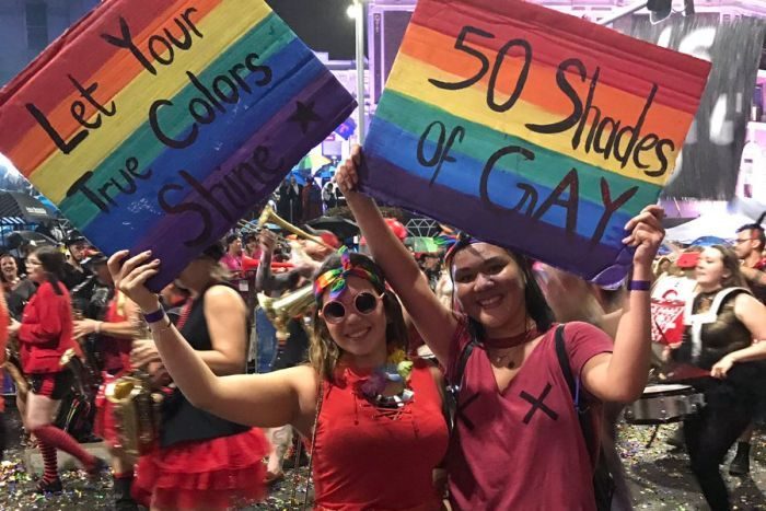 2 women in red Pride parade