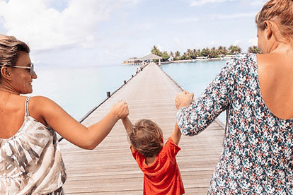 2 women walking with child