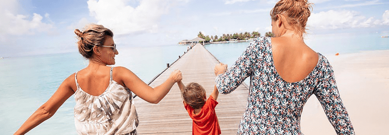 2 women walking with child