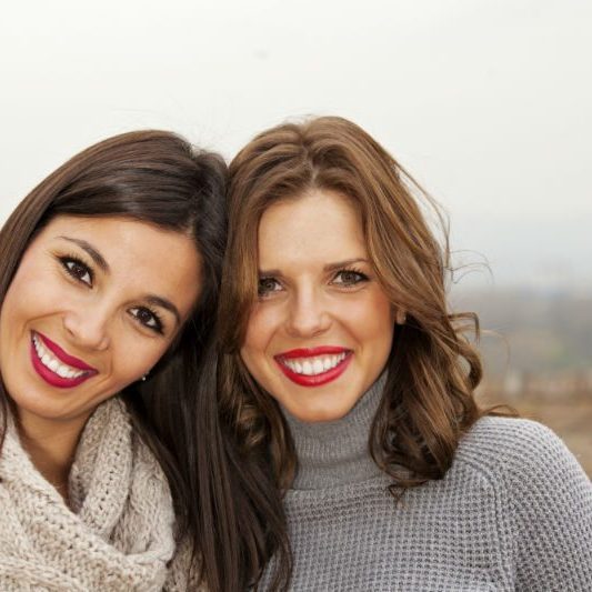 2 young women smiling at camera
