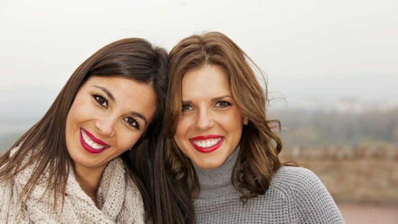 2 young women smiling at camera