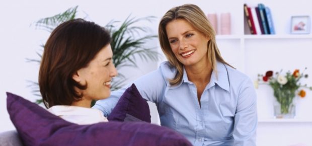 2 women sitting on the lounge