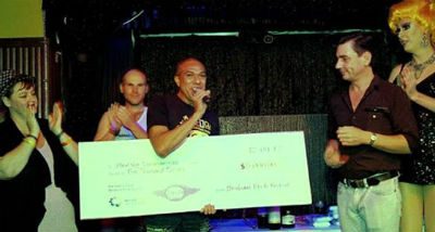 Brisbane Pride Festival President, Peter Black handing over oversized cheque