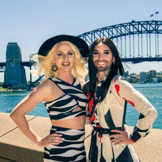 Conchita Wurst and Courtney Act posing infront of Sydney Harbour Bridge