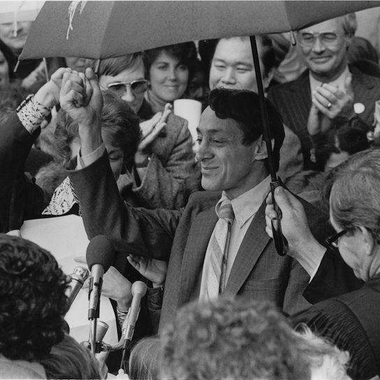 Harvey Milk surounded by people
