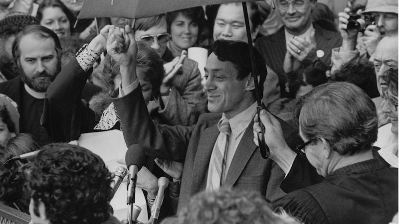 Harvey Milk surounded by people